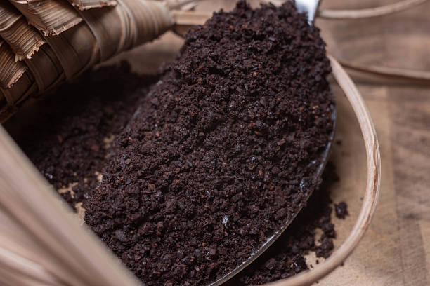 istock A spoon with ground roasted coffee on a wooden board with a braided decoration 2243572219