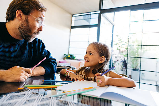 istock Father and daughter create art at home 2243573874