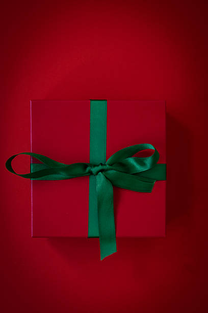 Christmas or birthday gift box on red background