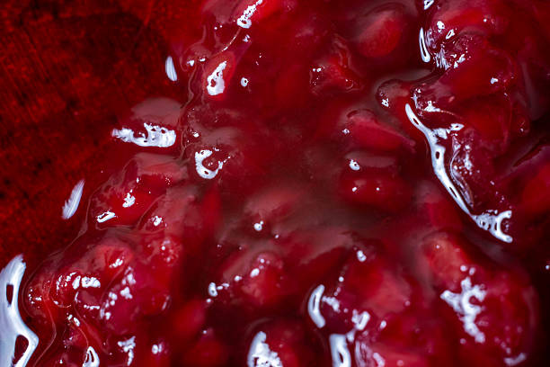 istock Raspberry jam is poured on a wooden stand 2243574634