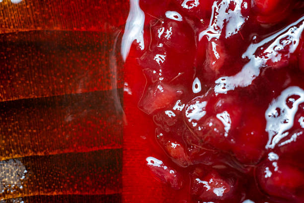 istock Raspberry jam is poured on a wooden stand 2243576433