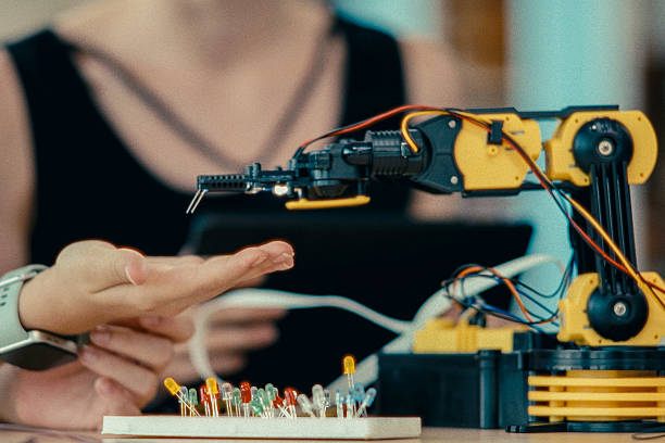 istock Female educator teaching young students about robotics and ai in a school science lab. 2243577929