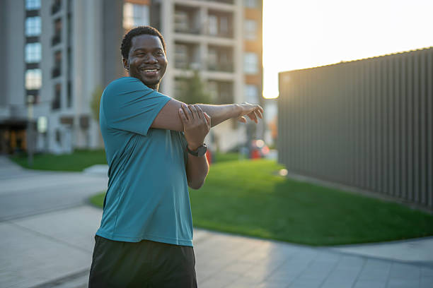 istock Happy man stretching shoulder before urban workout 2243578092