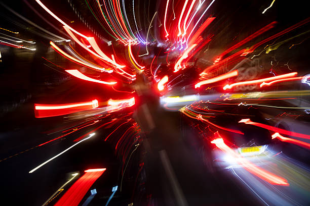 Abstract long exposure image capturing the dynamic movement of car lights at night. Red, white, and yellow streaks create an energetic urban composition full of speed, motion, and chaos — evoking the pulse of modern city life. Perfect for illustrating technology, nightlife, transportation, or creative design concepts.