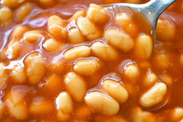 istock Baked beans in tomato sauce on spoon. 2243580496