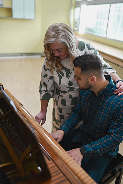 istock Dedicated Male And Female Pianists Concentrating Deeply While Playing Duet In Music Class 2243583772
