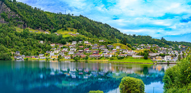 Hardangerfjord, Scenic Norheimsund waterfront skyline reflecting on calm fjord waters in western Norway Hardanger region summer