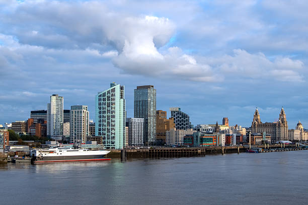 Liverpool city skyline, waterfront and the three graces (The Royal Liver, the Cunard and the Port of Liverpool Buildings) on the River Mersey in North West England, UK.