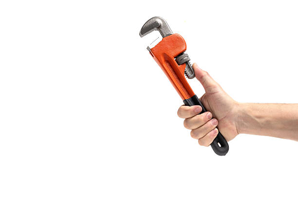 istock Adjustable pipe wrench in hand isolated on white background. 2243588775