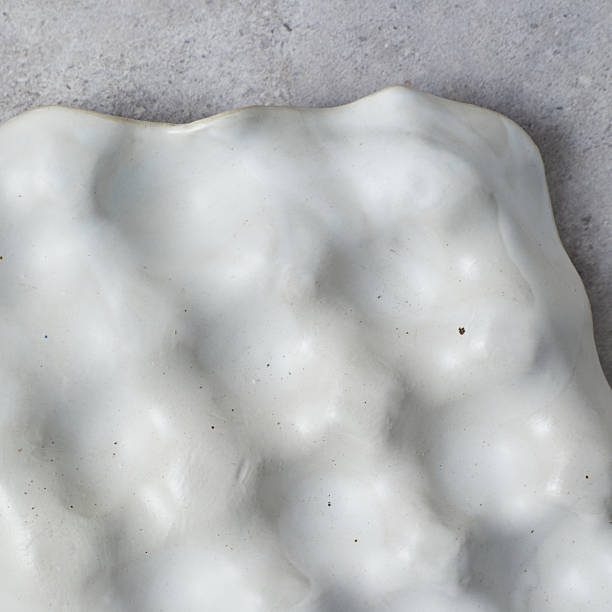 istock ceramic tray for jewelry on gray background. 2243589068