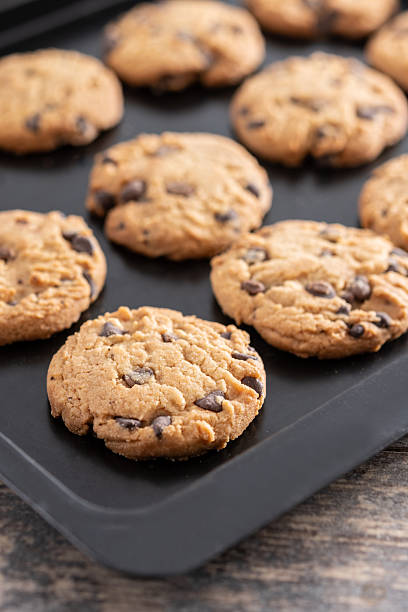 istock Baked chocolate chip cookies on a black baking tray 2243589529