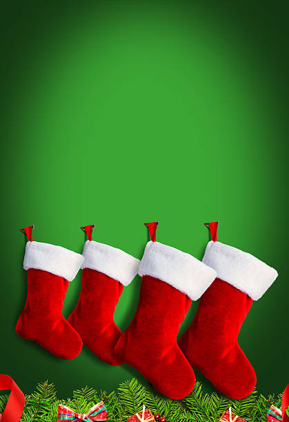 Four Christmas stockings above a pine bough on a green background.
