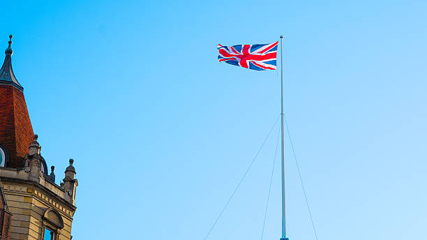 istock Union Jack flag fluttering against blue sky representing London and British heritage 2243589885