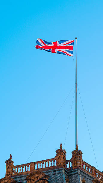 istock Union Jack flag fluttering against blue sky representing London and British heritage 2243589892