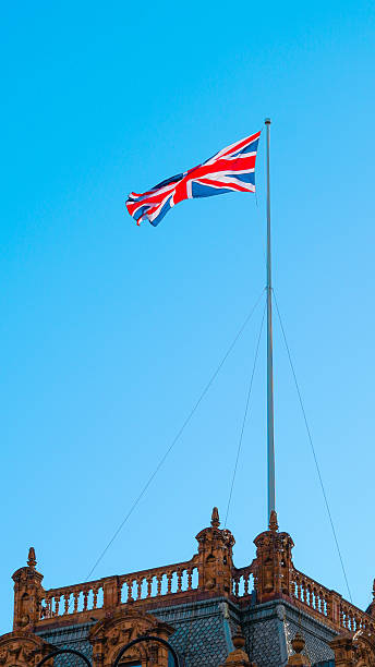 istock Union Jack flag fluttering against blue sky representing London and British heritage 2243589922