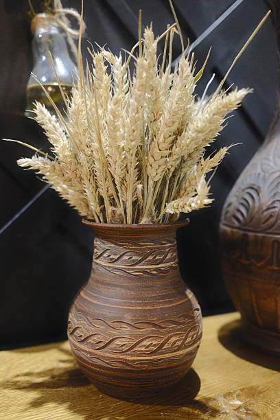 istock A clay vase holds wheat. The background is dark 2243591067