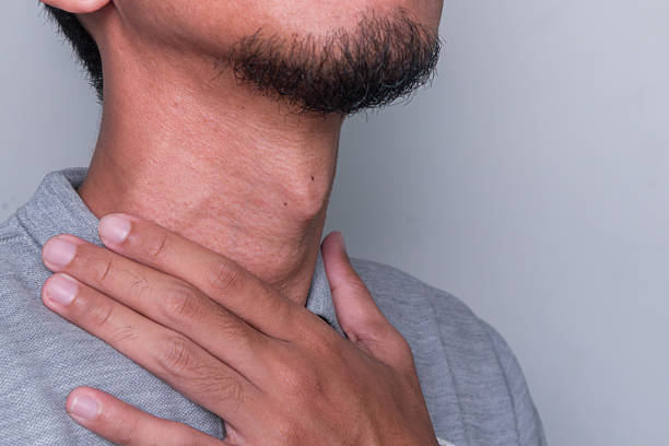 istock A man feeling painful in the throat 2243591995