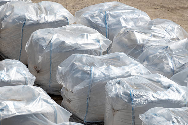 istock Large industrial packaging bags covered in plastic wrap outdoors 2243594859
