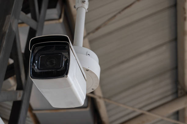 istock Security Eye Vigilant CCTV camera under industrial structure with monitoring area. 2243597195
