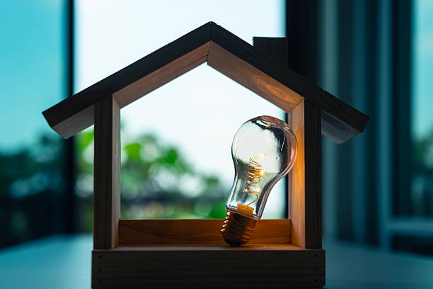 istock Creative concept of a light bulb glowing inside a wooden house frame, symbolizing smart home ideas, energy efficiency, innovation, home electricity, or sustainable technology. 2243598784
