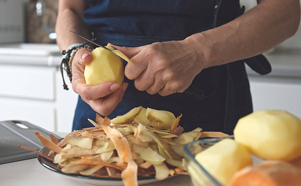 istock Woman Is Peeling Potatoes 2243598928