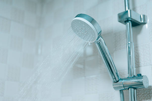 istock Modern bathroom shower head with running water in a clean interior, representing hygiene, freshness, comfort, and contemporary lifestyle design in a hotel or home environment. 2243600432