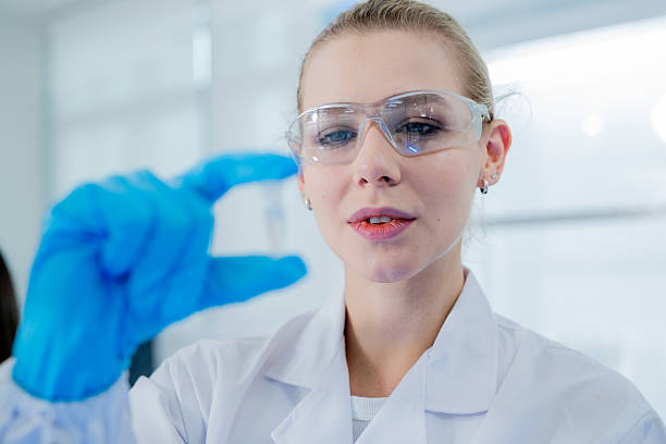 istock Scientist demonstrating precision in laboratory during an experiment with protective gear 2243600484