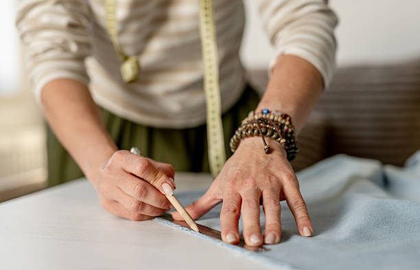 istock Woman Drawing Line On Fabric With Ruler 2243600693