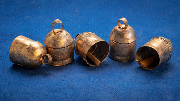 Handmade vintage indian tin bells on blue art paper