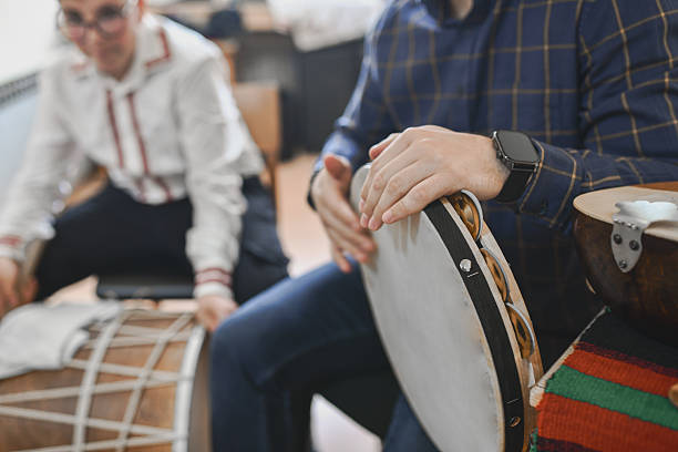istock Teacher Playing Traditional Music With Boys During Interactive Classroom Music Session 2243605349