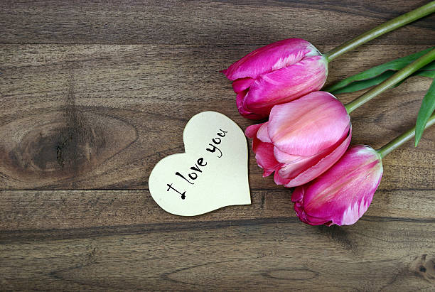 istock I love you. tulips on a wooden table. top view. copy space 2243607140