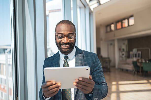 istock Confident businessman working on a tablet in a modern office environment 2243607505