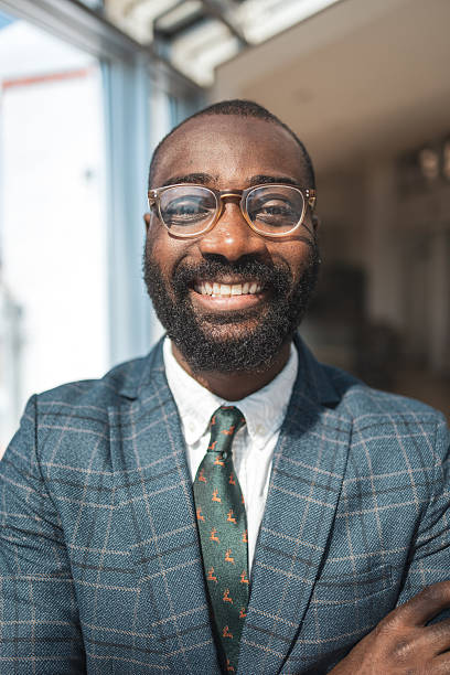istock Smiling professional man in office setting with natural lighting wearing glasses 2243607506