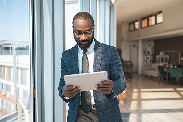 istock Business professional working on a tablet in a modern bright office environment 2243607507