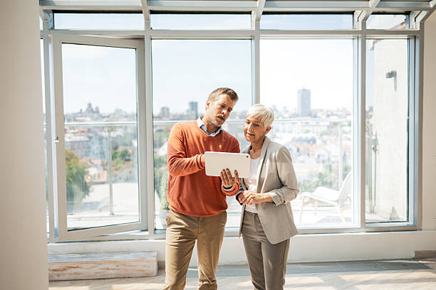 istock Business professionals discussing details using a tablet in a modern office space 2243607866