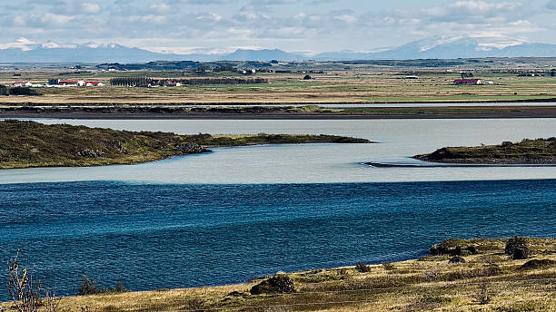 istock Iceland Lake Landscape Distant Mountains Village 2243610907