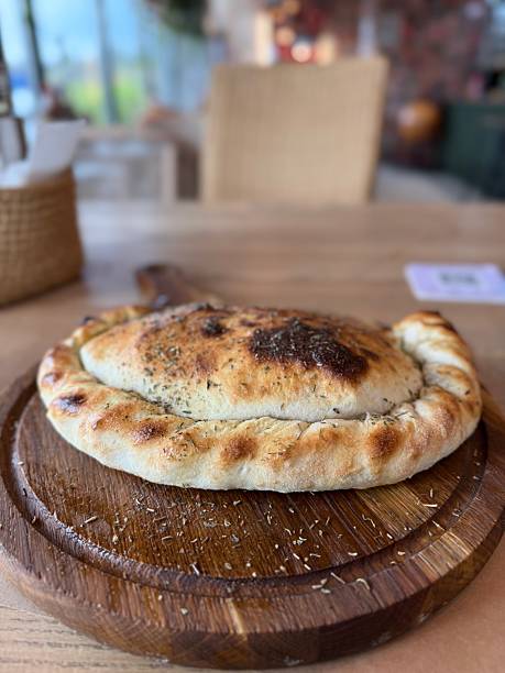 Freshly Baked Calzone on Wooden Board