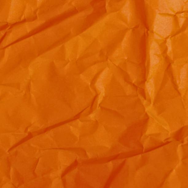 istock Close up of vibrant orange crinkled fabric texture 2243615862