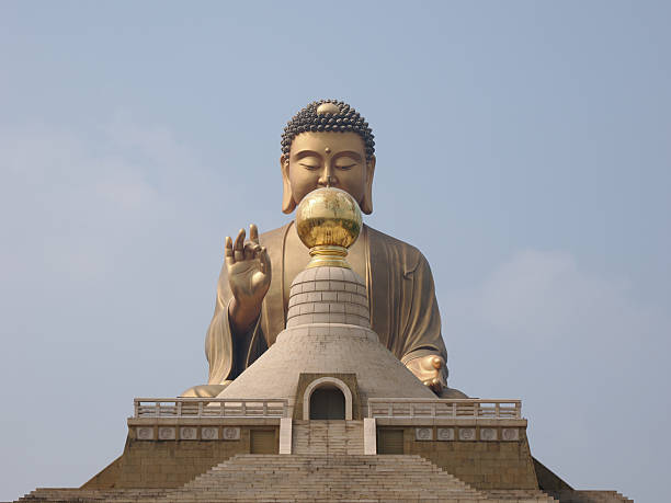 Kaohsiung, Taiwan - November 11 2024: A unique symmetrical close-up of the giant Fo Guang Big Buddha, with its face partially obscured by the golden stupa.