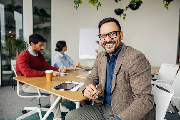 istock Professional businessman smiling during a meeting in office 2243620100