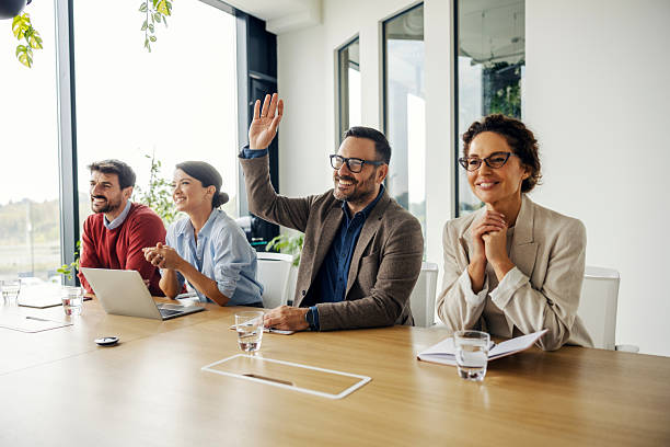 istock Business team participating in meeting, one man raising hand 2243620155