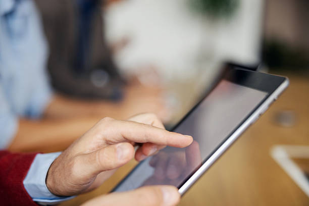 istock Person using a digital tablet in business meeting 2243620175