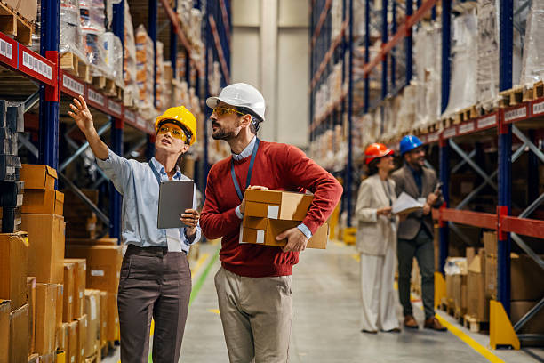 istock Warehouse workers managing inventory and inspecting stock 2243620314