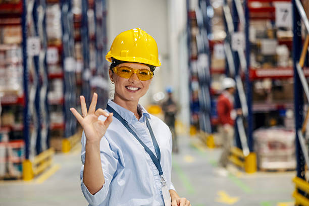 istock Female warehouse worker showing ok sign 2243620354