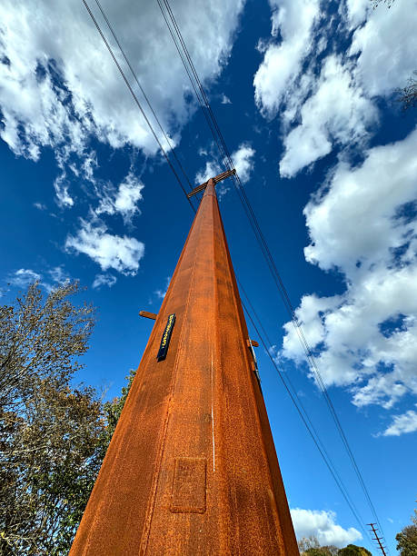 istock EX MS wide angle tall metal power line pole under blue sky with clouds 2243621198