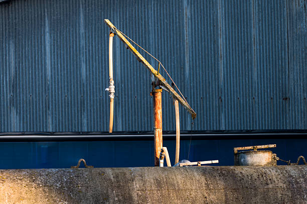 Dallon, France 07 Sep 2025: Loading arm at a grain factory along the Canal de Saint-Quentin in Dallon in early morning autumn sunlight
