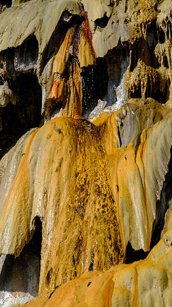 istock travertine waterfall close-up image, with mineral waters, the waterfall turned into chalky and colorful travertines. 2243624463