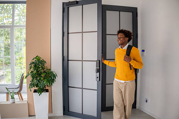 istock Black business professional enters modern office with a bright smile and backpack ready for a productive day 2243624490