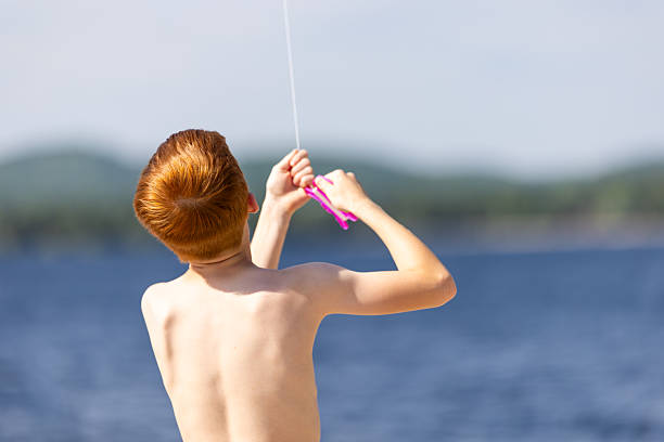 Young Redhead Boy Flying a Kite at the Beach During Summer, Quebec, Canada