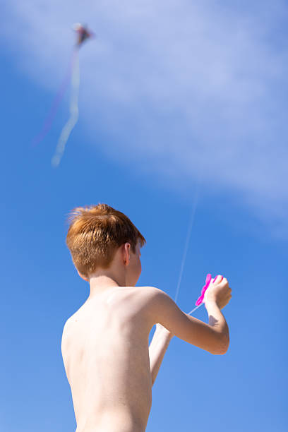 Young Redhead Boy Flying a Kite at the Beach During Summer, Quebec, Canada